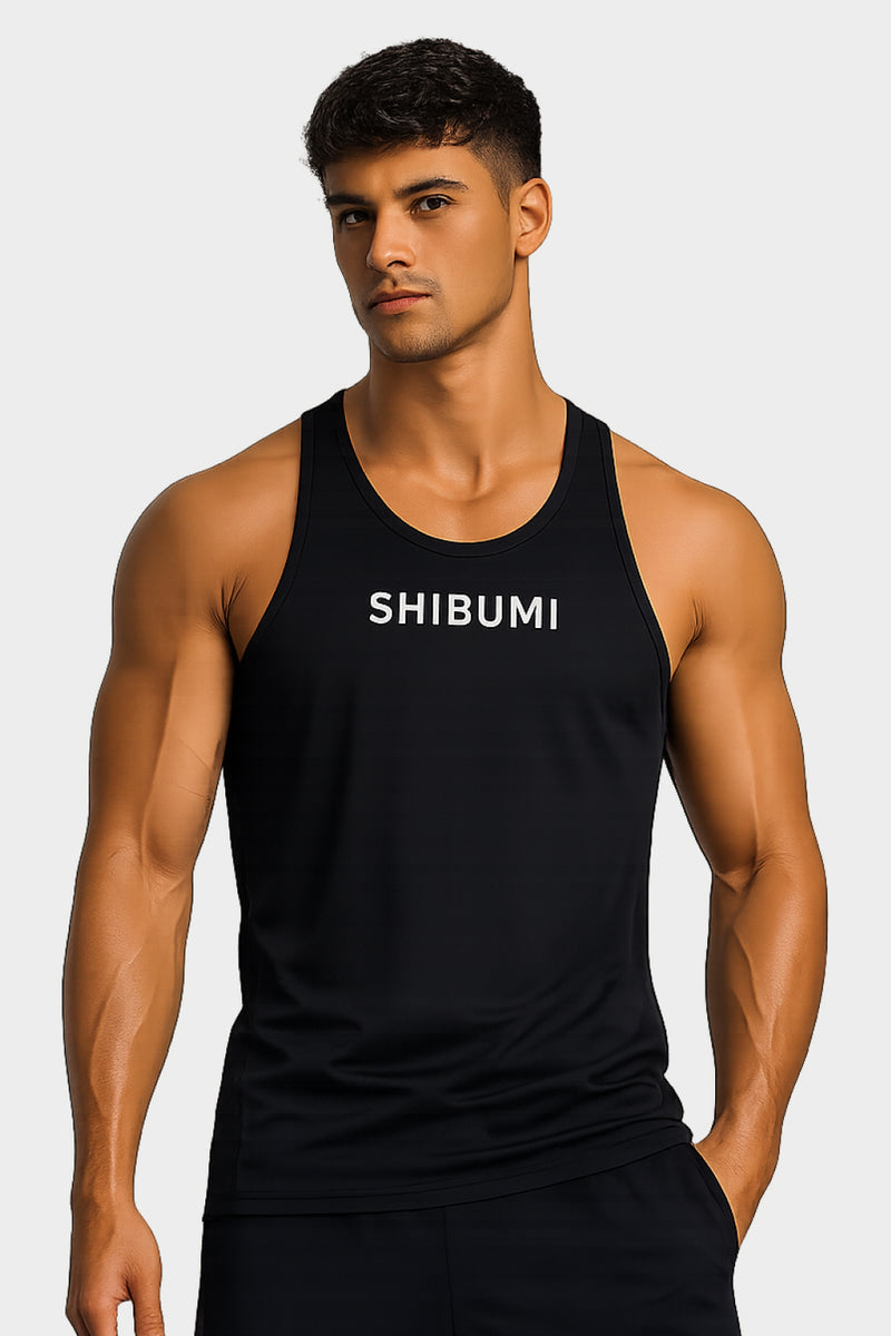 Man wearing a black tank top with 'SHIBUMI' text on a light gray background