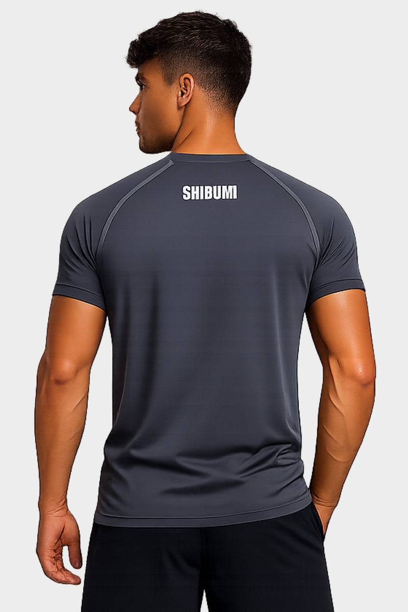 Person wearing a dark gray t-shirt with 'SKOSHIN' branding on the back against a white background