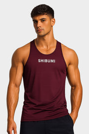 Man wearing a maroon tank top with 'SHIBUMI' text on a plain background