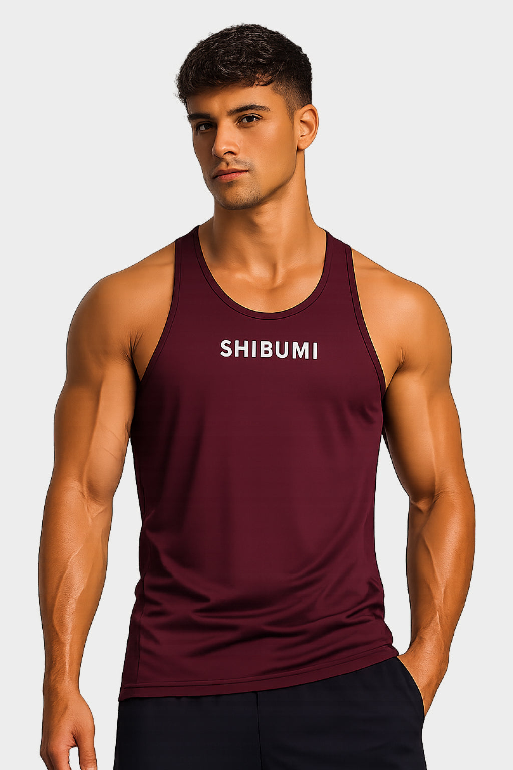 Man wearing a maroon tank top with 'SHIBUMI' text on a plain background