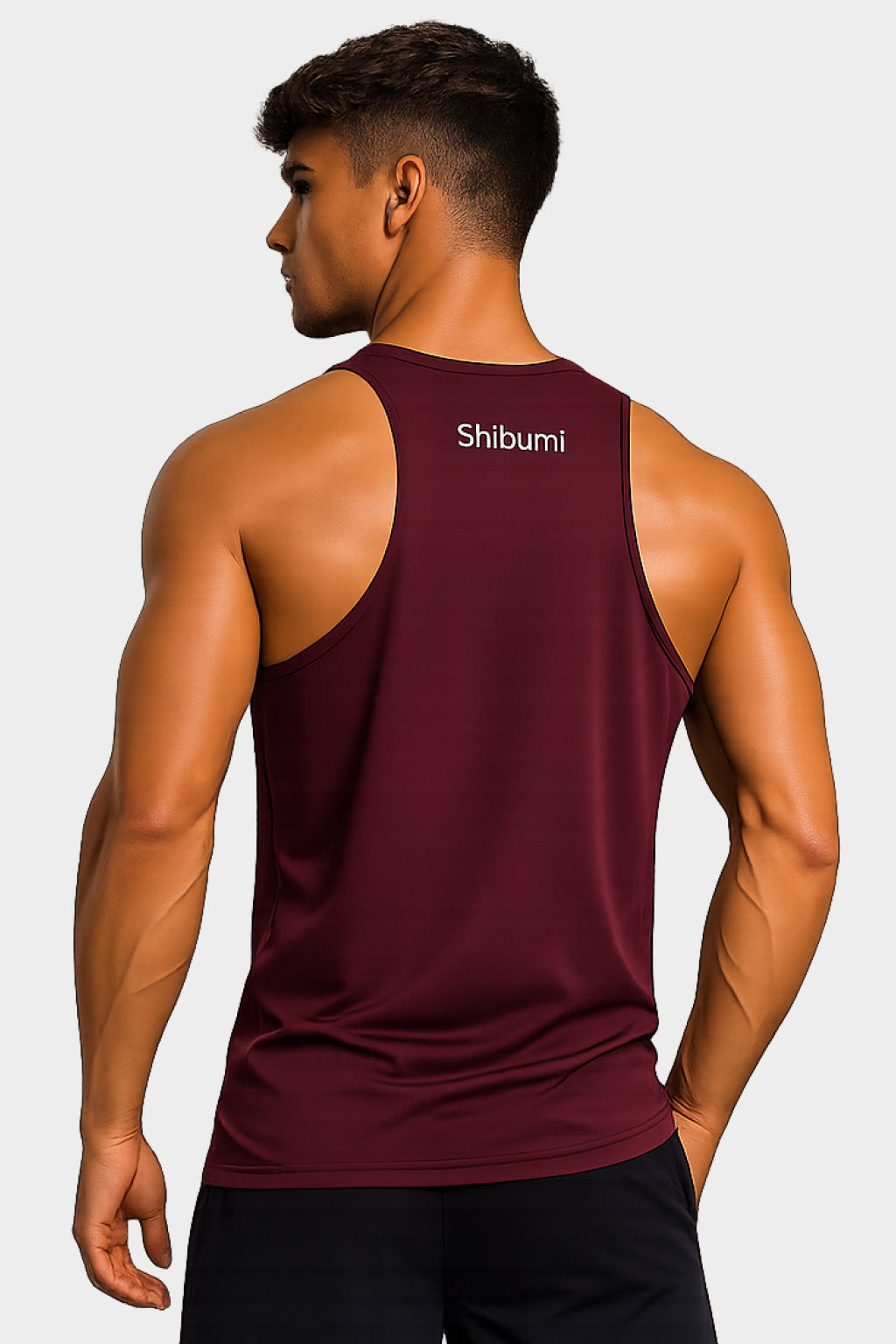 Man wearing a maroon tank top with 'Shibumi' branding on the back against a white background
