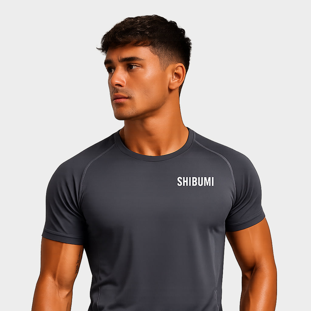 Man wearing a dark gray t-shirt with 'SHOSHIN' logo on a light gray background